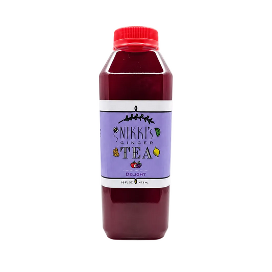 A bottle of Nikki's Ginger Tea, Delight flavor, filled with a deep red-brown tea and featuring a purple label with a red cap, set against a plain white background.