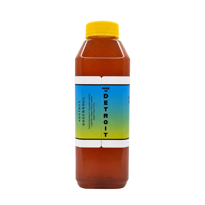 A bottle of tea, featuring amber liquid, a bright yellow cap, and a blue-to-yellow gradient label on a white background.