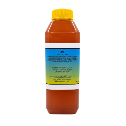 A bottle of tea with a yellow cap and a blue-to-yellow gradient label, shown on a white background.