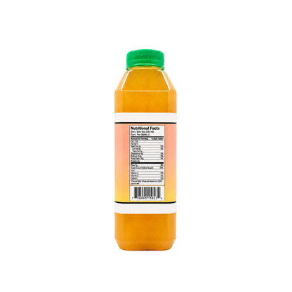 A plastic bottle of orange juice with a green cap, showing the back label with nutritional facts, on a solid off-white background.