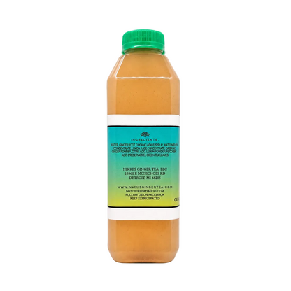 Back view of a clear plastic bottle of Ginger Watermelon Lemonade with a green cap, featuring an aqua label displaying the full list of ingredients, company address in Detroit, MI, website, and refrigeration instructions.