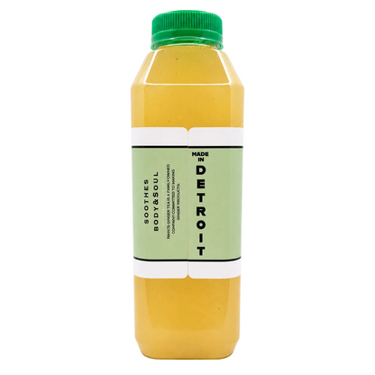 A bottle featuring a translucent yellow liquid, a green cap, and a light green label with black text, set against a plain white background.
