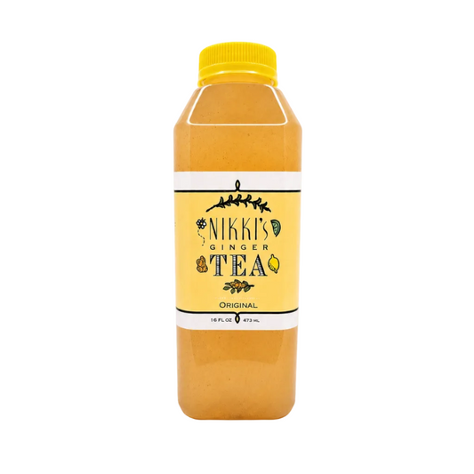 A bottle of Nikki's Ginger Tea Original on a clean white background. The bottle is filled with a golden-amber tea and features a bright yellow cap and a yellow label with black text and illustrations.