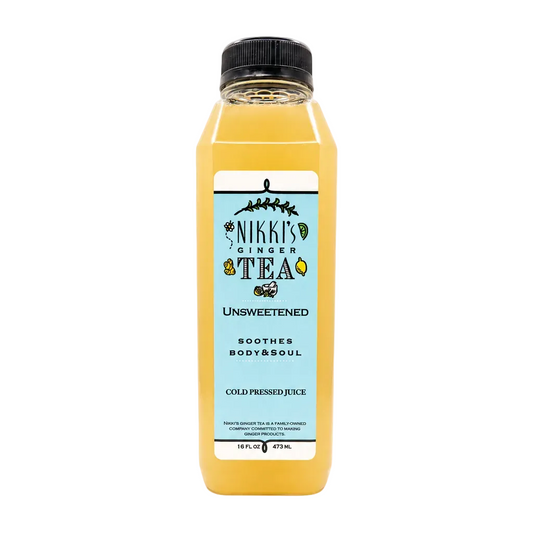 A bottle of Nikki's Ginger Tea Unsweetened cold pressed juice, filled with a golden yellow liquid, featuring a light blue label and a black cap, set against a plain white background.